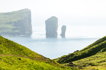Dramatic view on Drangarnir and Tindholmur sea stacks in Atlantic ocean from Vagar island, Faroe Islands. Landscape photography