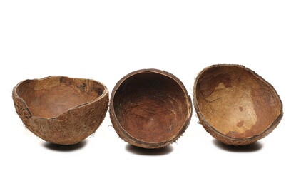 Coconut fruit shells cut in half isolated on white background side view