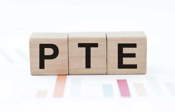 PTE - acronym from wooden blocks with letters, Pearson Tests of English PTE concept Foreign Language exams.