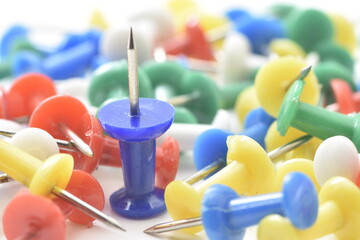 a lot of colorful pushpin close up on white background.