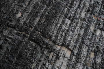 Parallel striped lines of mountain close up. Gray striped rock. Texture natural minimalistic stone background.