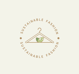 Sustainable fashion logo.Eco friendly production.Label,icon badge with clothes hanger and green leaves for natural recycling clothing,ethical fabric and slow fashion with sustainable materials.Vector