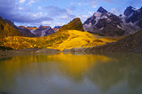 Sunset on Lake Bashkara against the background of the Caucasian Wall in the Elbrus region