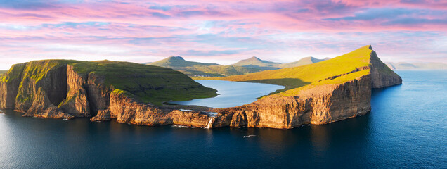 Aerial view from drone of Sorvagsvatn lake on cliffs of Vagar island in sunset time, Faroe Islands,...