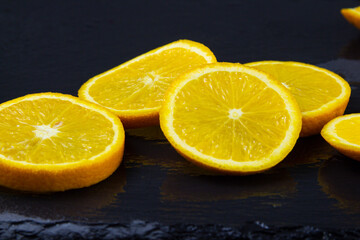 orange slices on a dark background close up