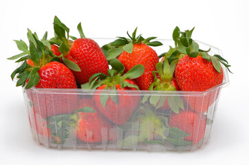 appetizing strawberries in a box close-up on a white background isolated