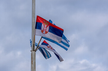 Flags of the Republic of Serbia and Greece on a pole in Belgrade, Serbia