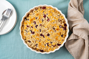Whole apple and pear crumble with ice cream, oats streusel. Sweet dessert with stewed fruit topped...