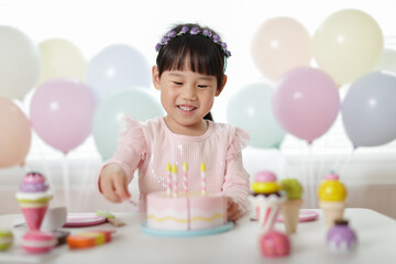 young girl pretend playing food preparing at home