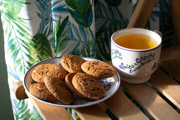 cup of tea on the table with biscuits cookies sunny day summer