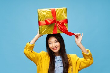 Fototapeta na wymiar cheerful woman with a gift in her hands holiday birthday blue background