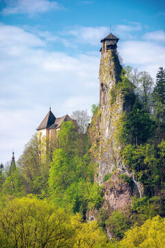 oravsky podzamok, slovakia - MAY 01, 2019: castle tower on the rock. beautiful sunny landscape in springtime. trees in green foliage on the meadow beneath a sky with clouds. popular travel destination