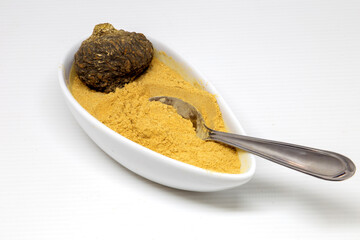 Peruvian maca roots or Peruvian ginseng (lat. Lepidium meyenii) with maca products (maca powder) on white background