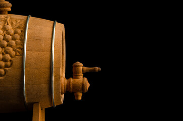 wooden wine barrel with tap isolate on black background. copy space