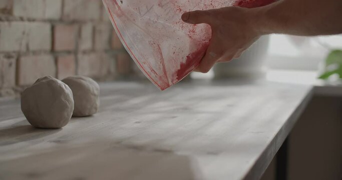 Ceramist pours dry dye for kneading colored clay, nerikomi pottery, potter's workshop, 4k 60p Prores HQ 10 bit