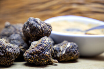 Peruvian maca roots or Peruvian ginseng (lat. Lepidium meyenii) with maca products (maca powder) on a wooden background