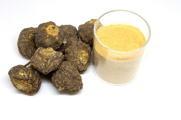 Peruvian maca roots or Peruvian ginseng (lat. Lepidium meyenii) with maca products (maca powder) on white background