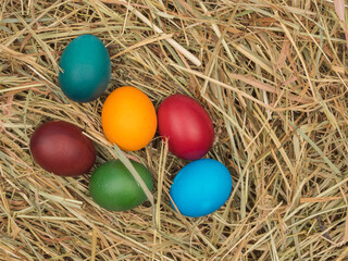Easter eggs in the hay close-up. Organic food.