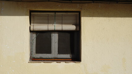old window with roller shutter