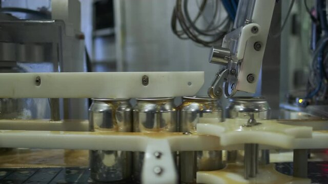 First Operation Seamer Fits Lids On Freshly Filled Beer Cans