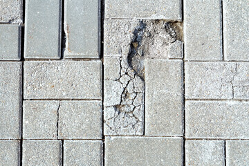 Collapsing low-quality gray paving slabs with a layered top layer