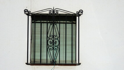 rustic window on white facade and grille