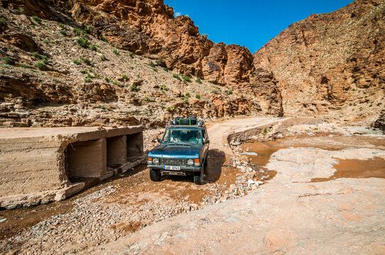 Aouli, Morocco - April 10, 2015. Old vintage Range Rover Classic going in the valley around abandoned mines  