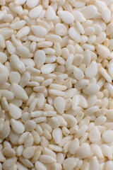 Organic natural white sesame seeds. Closeup til shot for use as background or as texture