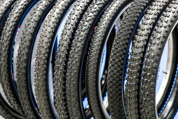 Lots of bike tires. Group of bicycle tires in the store. Different types of tires for bicycle wheels