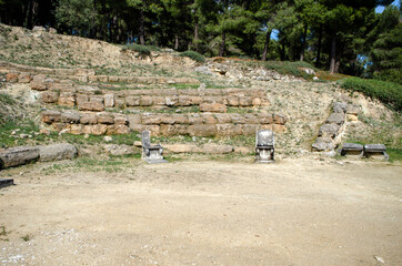 The theatre of the Amphiareion oropos Greece, behind The marble throne is the Kerkis were the wedge-shaped sections of banks of stone seats