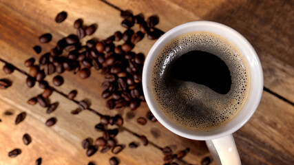 Freshly brewed cup of coffee on a wooden table - studio photography