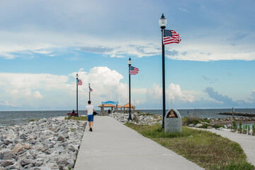 Seascape. Wooden pier with gazebos with orange roofs. Summer background. Ken Combs Pier, Gulfport, MS, USA