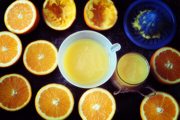 Orange fresh juice in a juicer and glass. Fresh oranges.