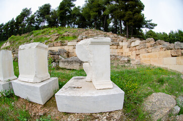 Parallel to the great retaining wall a series of monumental bases held votives to Amphiaraus
