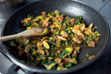 Delicious food with mushrooms and Zucchini in frying pan