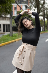 urban style with young latin woman with long hair around the city, fashion and lifestyle