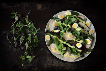 Nutritious salad with chicken breast and quail eggs. Keto diet salad.