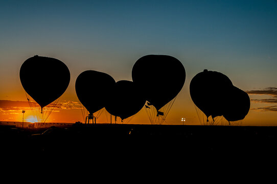 Silhouette Of Gas Balloons At Sunset