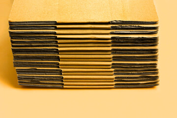 Stacking of cardboard boxes, Corrugated paper on yellow background.