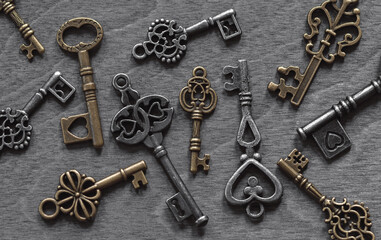 Retro keys collection on old wooden background