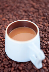 Fototapeta premium Hot coffee on coffee beans