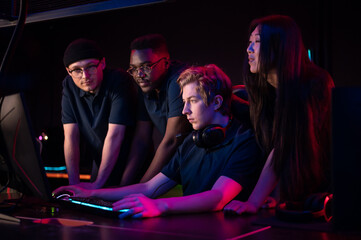 Players of the esports team gathered together in the computer club and watch the stream from the dota 2 world championship