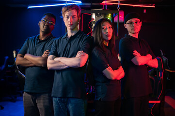 To represent the teams at the grand esports tournament, multinational guys and a girl look into the camera and fold their arms over their chests