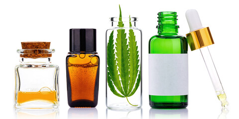 Glass bottles of cannabis oil and hemp leaves isolated on white background. Concept of using hemp in medicine..