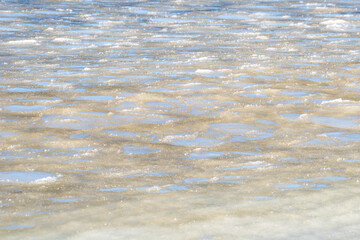 Frozen crystallized water and ice, on the surface of the blue ocean with a slight skim of frozen...