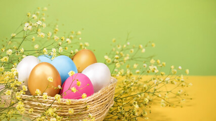 Easter eggs and flowers on a yellow and green background. Easter card.