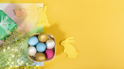 Easter eggs and bunnies on a yellow background. Easter banner.