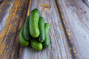 Green cucumbers on wooden background