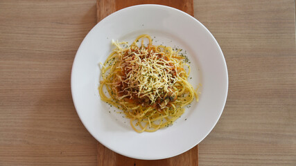 Spicy spaghetti with cheese served on the table. Photo concept for commercial use