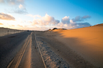 Road through sand dunes at sunset in Guadalupe-Nipomo Dunes National Wildlife reserve, California